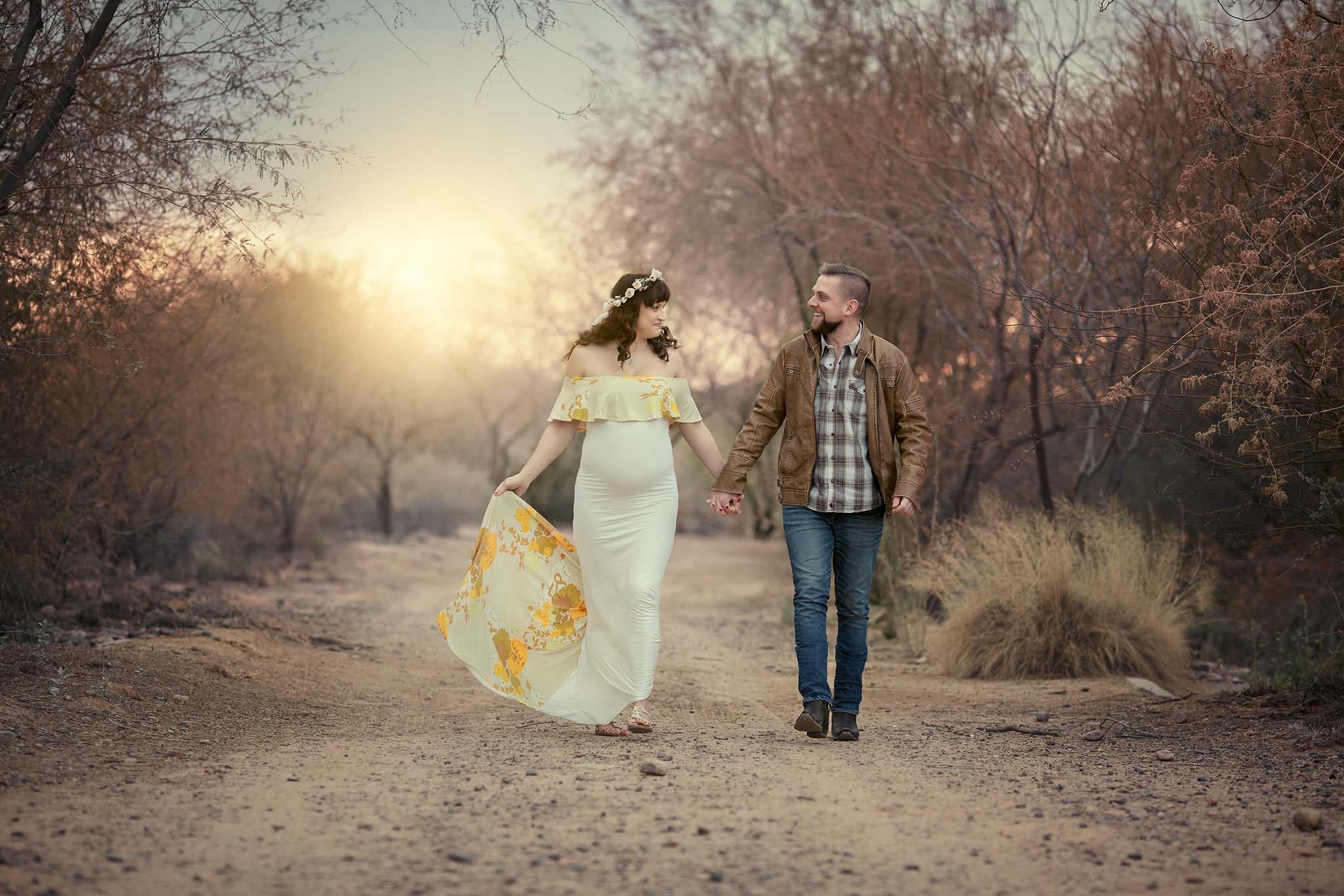Couple walking hand in hand in Phoenix in the rain for their maternity photograph
