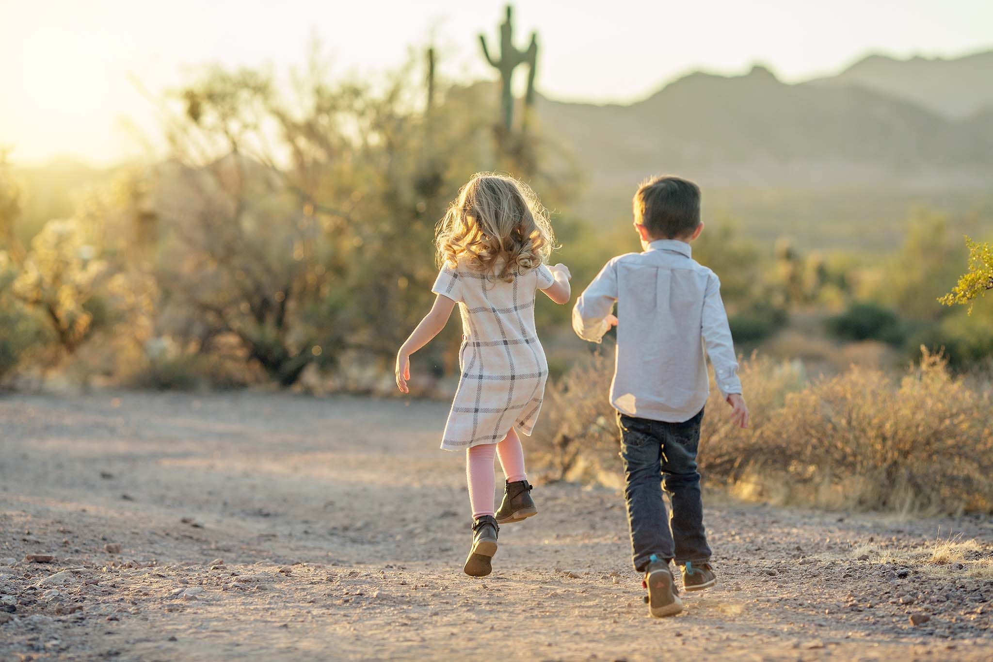 Candid childrne's portrati of twins running away at Lost Dutchman
