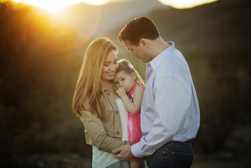Family of three with a toddler girl at sunset in Ahwatukee