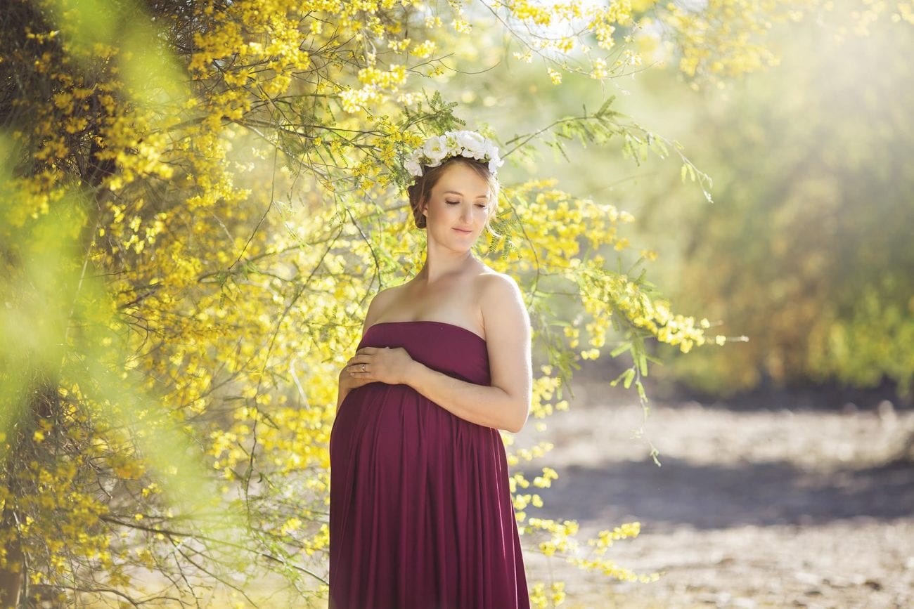Pregnant woman in yellow flowers filed in Central Phoneix
