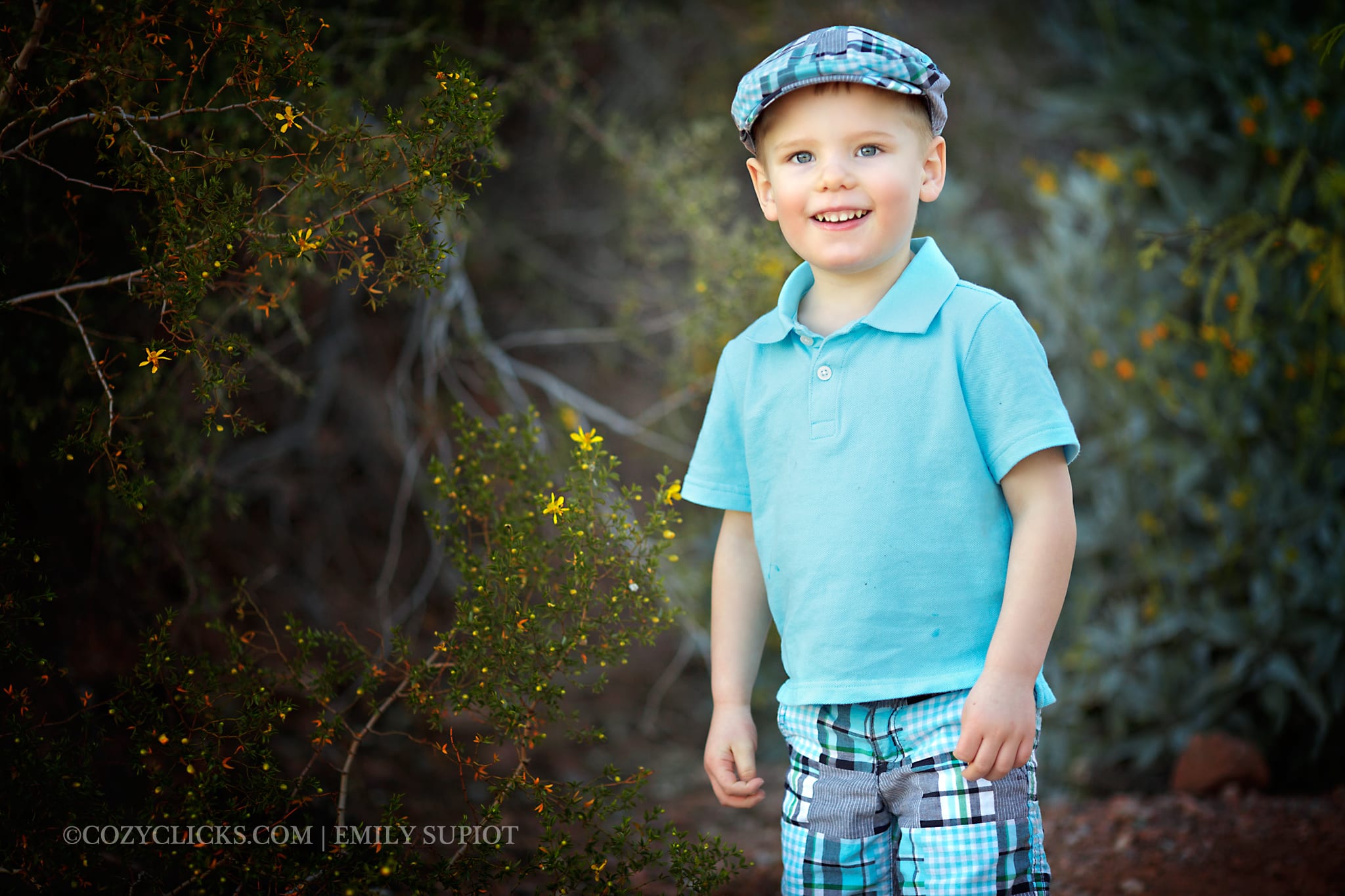 Child photo of two year old boy smiling big with a cute golfers cap on