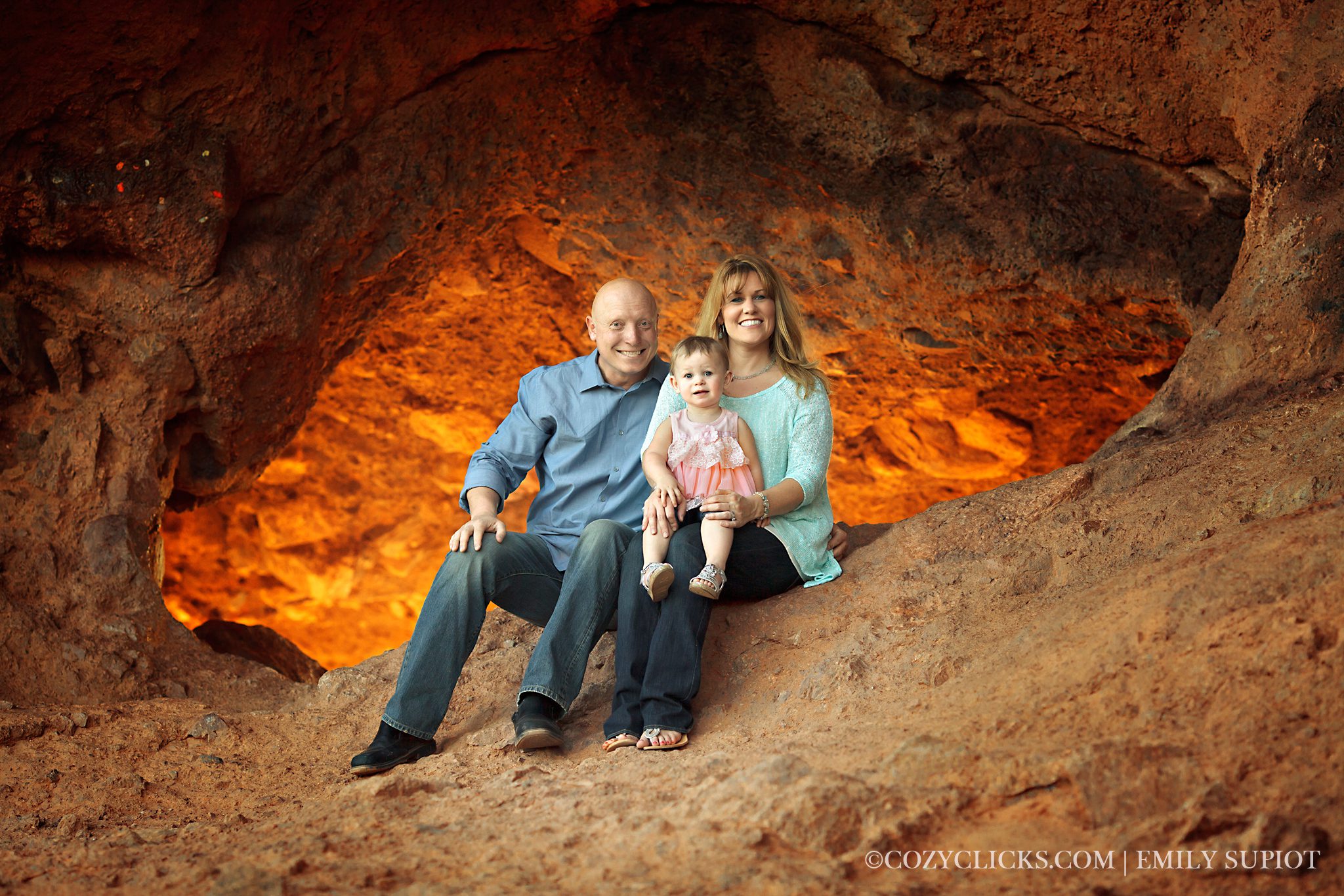Family photo with mom, dad and 18 month old girl at the Hole in papago park