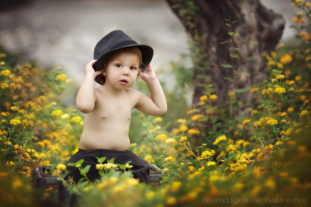 Toddler photos taken of one year old in yellow flowers garden in Ahwatukee, AZ