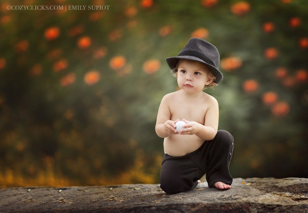 Cute one year old photo of child holding a golf ball in Phoenix, AZ