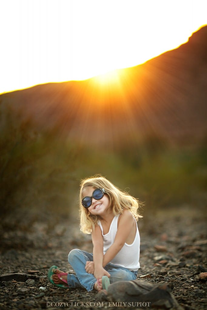 Four year old girl smiling big wearing sunglasses at South Mountain in Phoenix, Arizona