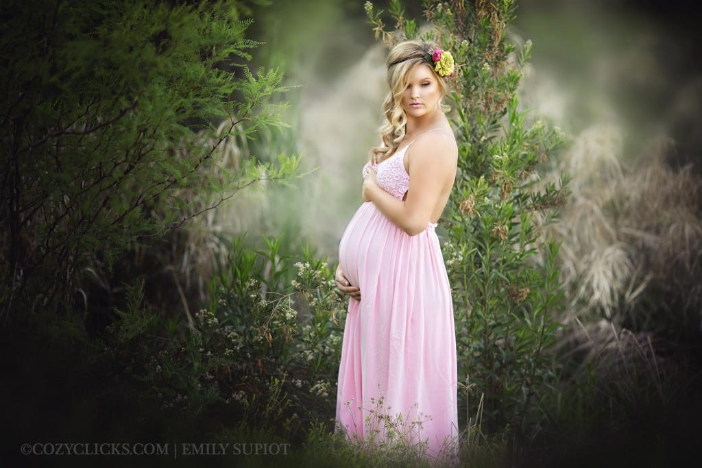 Prgnant mom looks over her shoulder in half body maternity pose taken in Phoenix, AZ