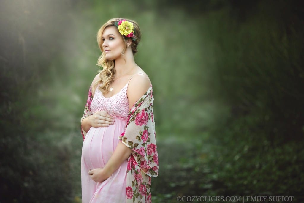 Pregnant mom looks out wearing pale pink gown with flower robe. Photograph taken at the Rio Salado Audobon Center close to Downtown Phoenix