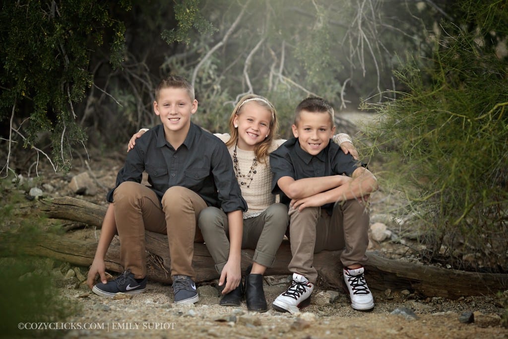 Three children 8-12 years old in a sibling portrait taken at South Mountain near Scottsdale
