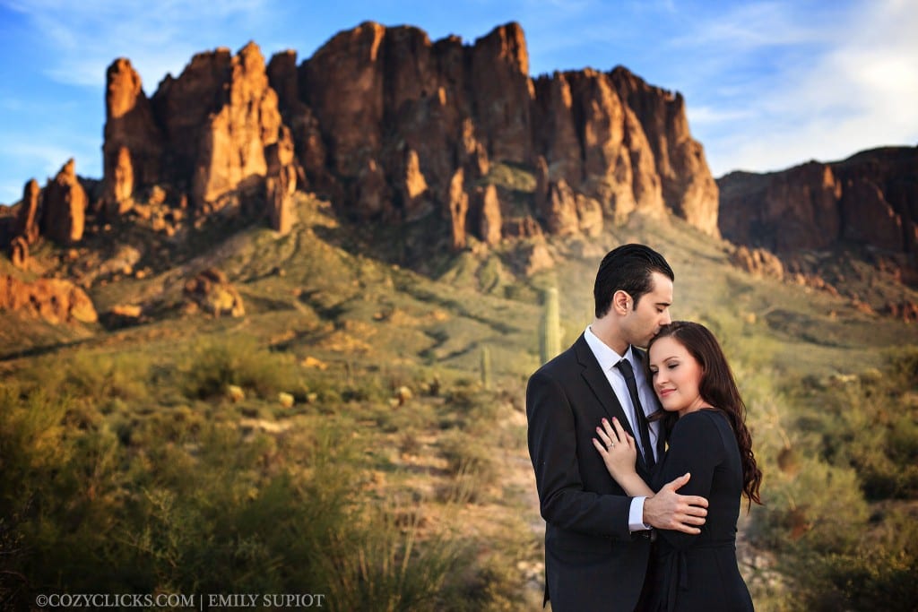 Couple poses for engagment photo in front of superstition Mountain in Apache juction