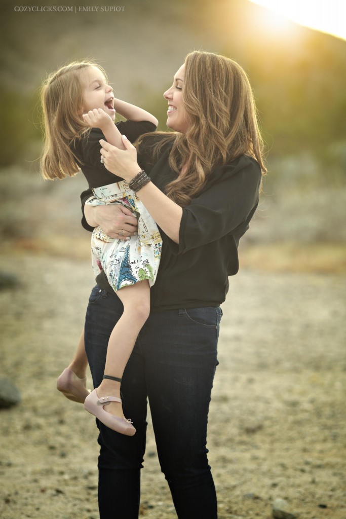 Mother and daughter laughing together in fun family portrait in Phoneix