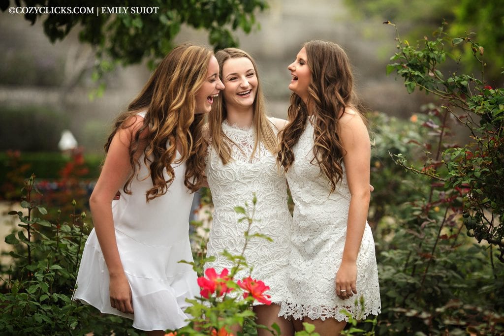 Three high school senior girls laugh together at Heritage Square Garden in downtown Phoneix