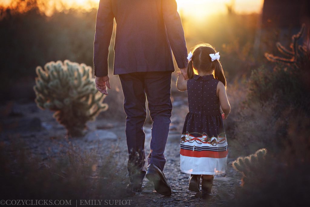 Father and daughter walk into the sunset in beautiful photograph at Gateway Trail head in Scottsdale, AZ