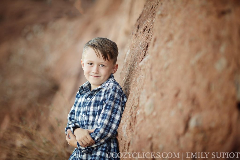 Child portrait of 6 year old boy near the red rock mountain of the Hole in the Rock in Phoenix, AZ