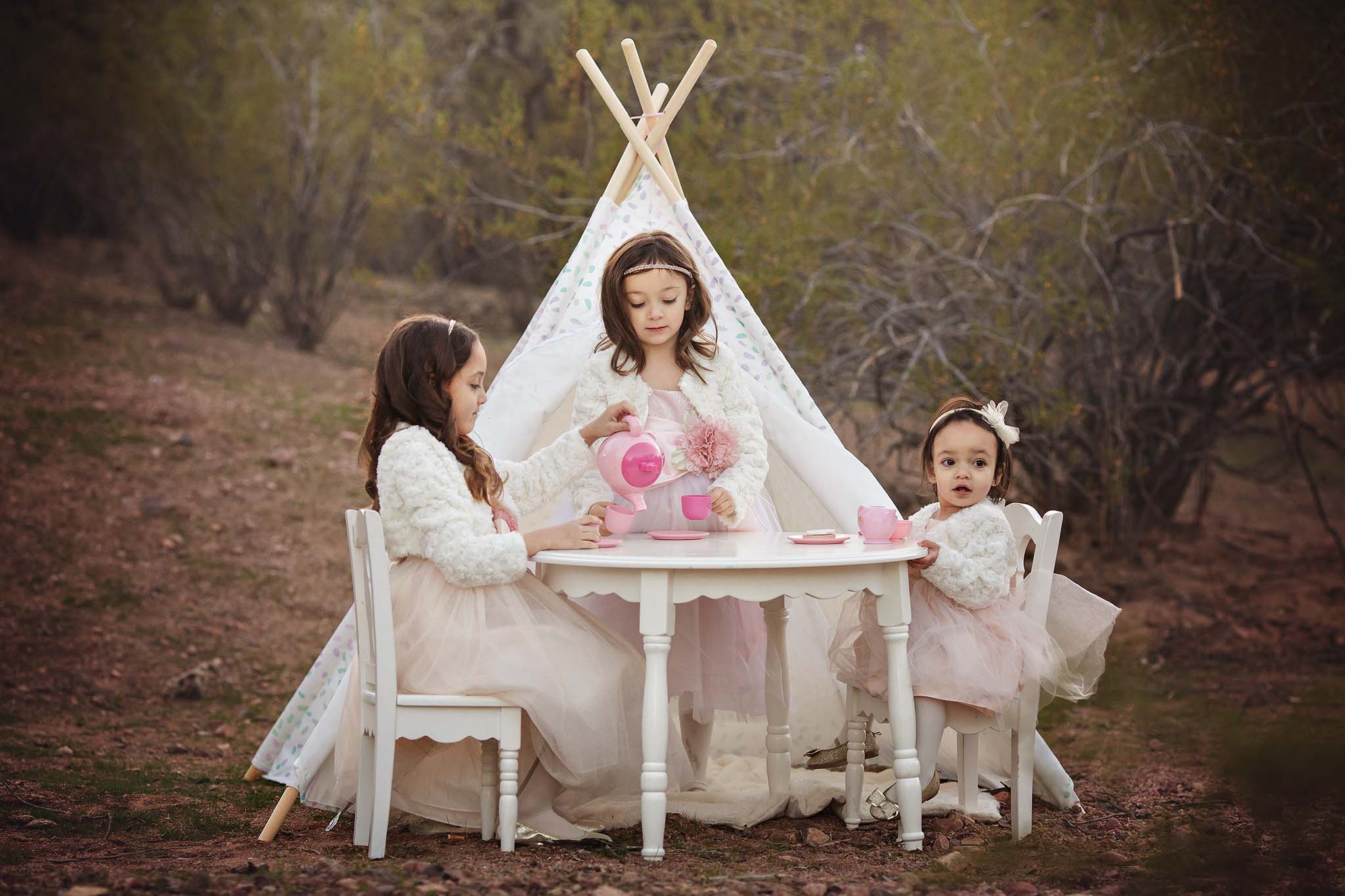 Sisiters using tea party props in their photo session in Phoenix Arizona