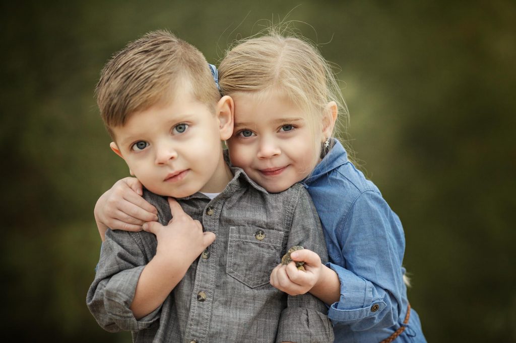 Two Young Siblings pose for a portrait in Phoenix taken by Cozy Clicks, voted the best Fmaily Photographer in Phoneix