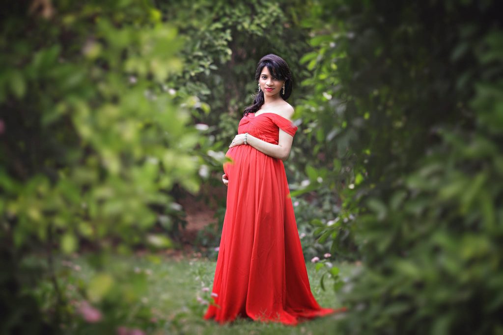 Materniy photography will red flowing dress in Glendale, Arizona