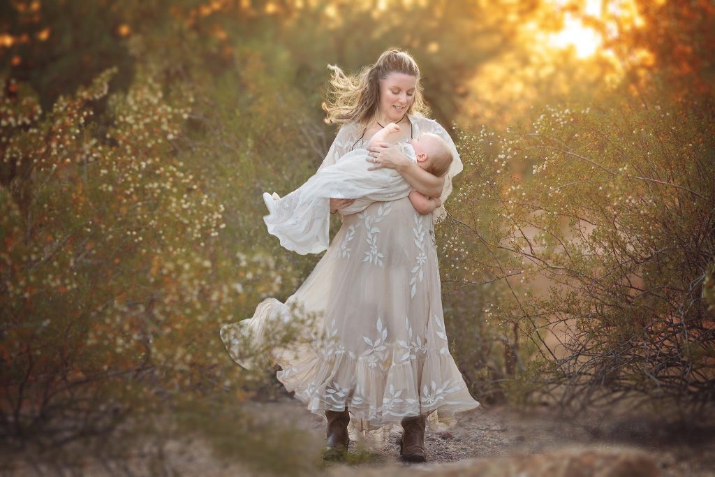 Mom and baby photo in the wind in the desert at sunset. Taken by best family photographer in Phoneix