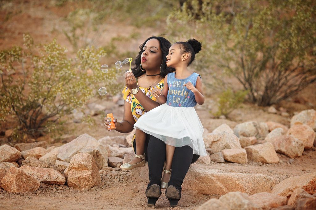 Candid mother and duaghter photo blowing bubbles tkaen by the beat family photographer in Phoenix